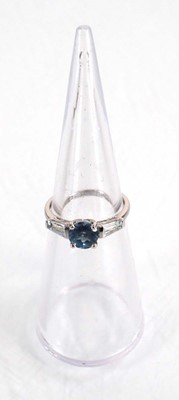 Lot 582 - A 9ct white gold ring set three graduated pale...