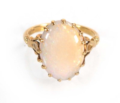 Lot 583 - An 18ct yellow gold set set oval opal within a...