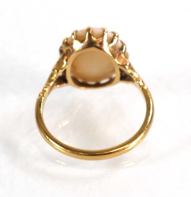 Lot 583 - An 18ct yellow gold set set oval opal within a...