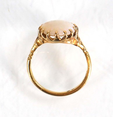 Lot 583 - An 18ct yellow gold set set oval opal within a...