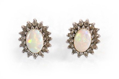 Lot 584 - A pair of 9ct yellow gold ear studs, each set...