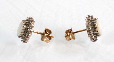 Lot 584 - A pair of 9ct yellow gold ear studs, each set...