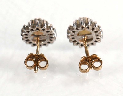Lot 584 - A pair of 9ct yellow gold ear studs, each set...