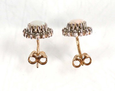 Lot 584 - A pair of 9ct yellow gold ear studs, each set...