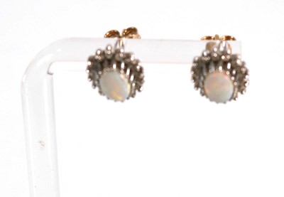 Lot 584 - A pair of 9ct yellow gold ear studs, each set...