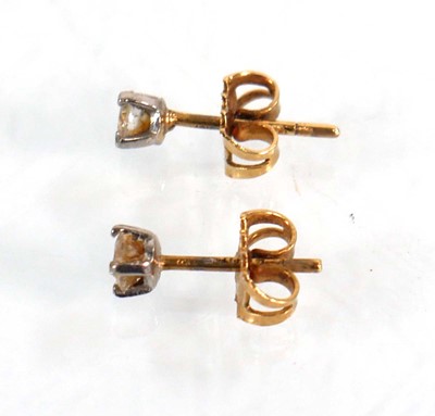 Lot 585 - A pair of 18ct yellow gold ear studs, each set...