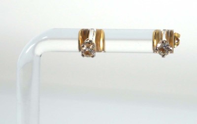 Lot 585 - A pair of 18ct yellow gold ear studs, each set...