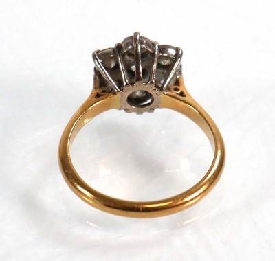 Lot 586 - An 18ct yellow gold cluster ring set seven...