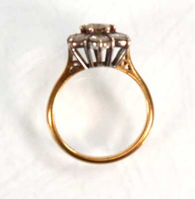 Lot 586 - An 18ct yellow gold cluster ring set seven...