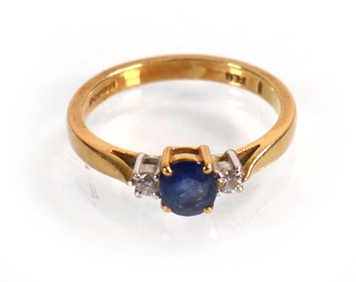Lot 587 - An 18ct yellow gold ring set oval sapphire in...