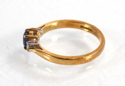 Lot 587 - An 18ct yellow gold ring set oval sapphire in...