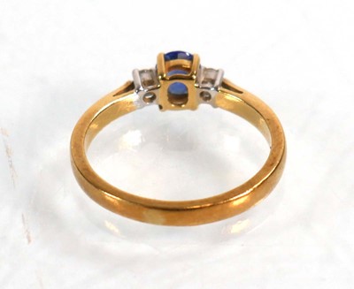 Lot 587 - An 18ct yellow gold ring set oval sapphire in...