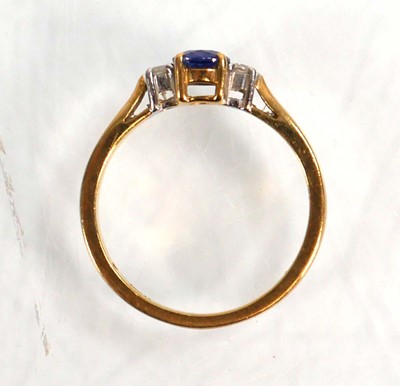 Lot 587 - An 18ct yellow gold ring set oval sapphire in...