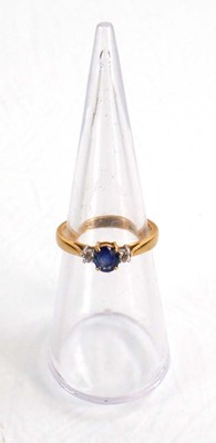 Lot 587 - An 18ct yellow gold ring set oval sapphire in...