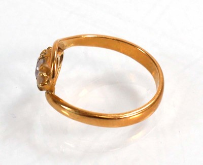 Lot 588 - A yellow metal crossover ring set three...