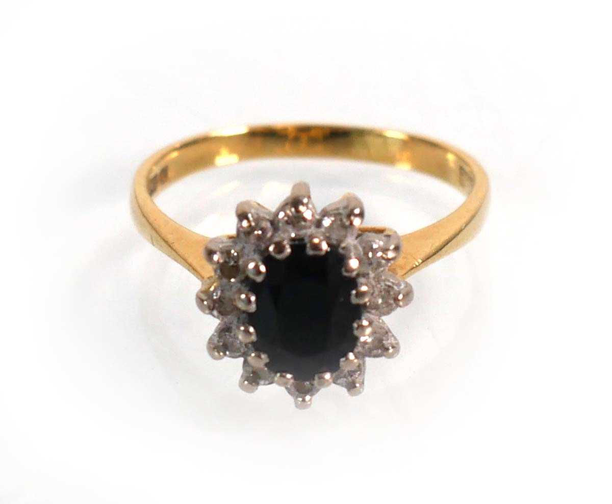 Lot 590 - An 18ct yellow gold cluster ring set oval...