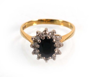Lot 590 - An 18ct yellow gold cluster ring set oval...