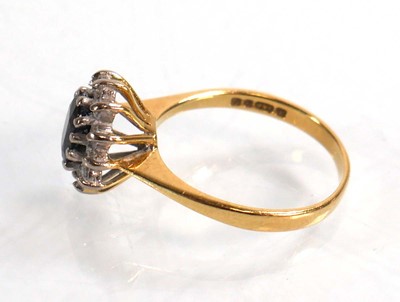 Lot 590 - An 18ct yellow gold cluster ring set oval...
