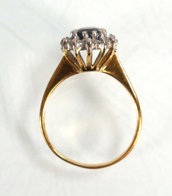 Lot 590 - An 18ct yellow gold cluster ring set oval...