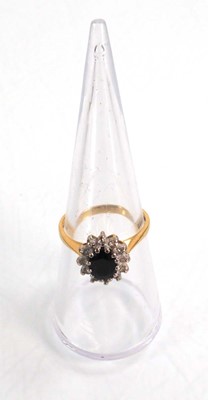 Lot 590 - An 18ct yellow gold cluster ring set oval...