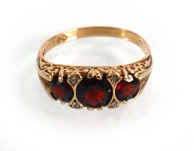 Lot 592 - A 9ct yellow gold ring set three graduated...