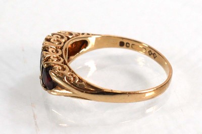 Lot 592 - A 9ct yellow gold ring set three graduated...