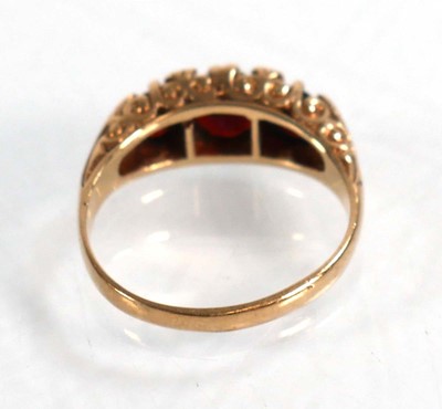 Lot 592 - A 9ct yellow gold ring set three graduated...