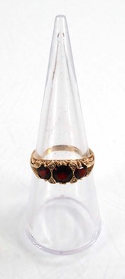 Lot 592 - A 9ct yellow gold ring set three graduated...
