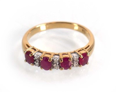 Lot 593 - A 9ct yellow gold ring set four oval rubies...