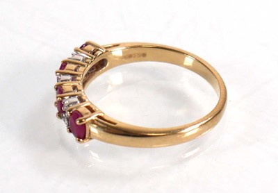 Lot 593 - A 9ct yellow gold ring set four oval rubies...