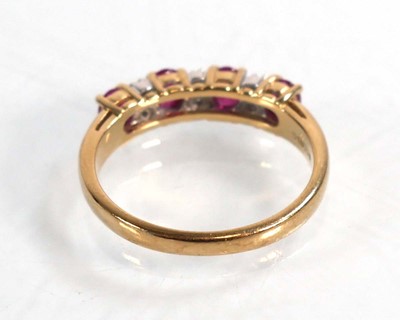 Lot 593 - A 9ct yellow gold ring set four oval rubies...