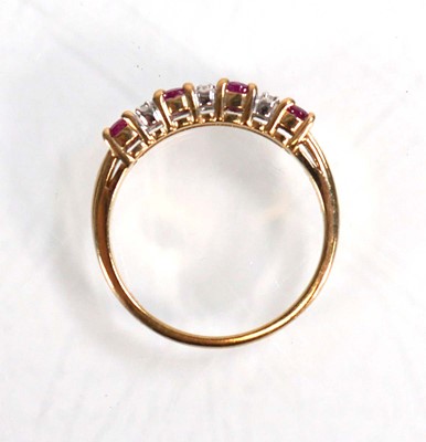Lot 593 - A 9ct yellow gold ring set four oval rubies...