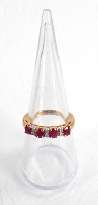 Lot 593 - A 9ct yellow gold ring set four oval rubies...