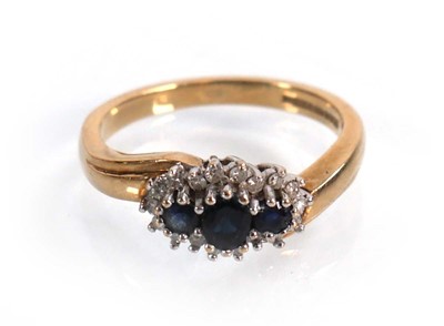 Lot 594 - A 9ct yellow gold crossover ring set three...