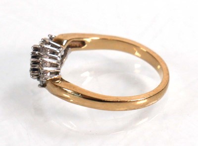 Lot 594 - A 9ct yellow gold crossover ring set three...