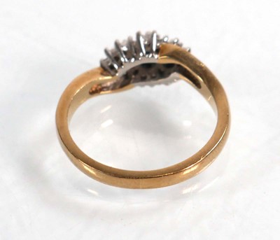 Lot 594 - A 9ct yellow gold crossover ring set three...