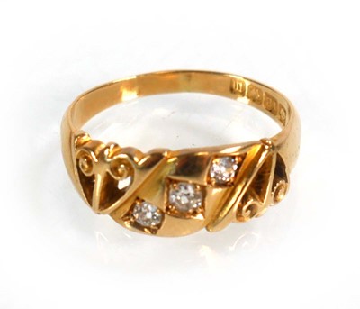 Lot 597 - An 18ct yellow gold ring set three small...