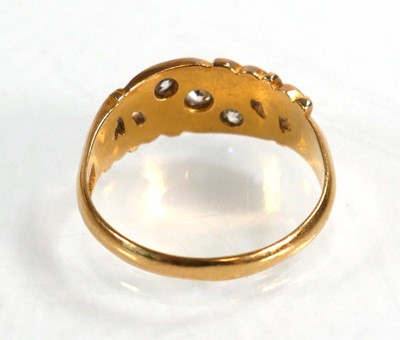 Lot 597 - An 18ct yellow gold ring set three small...