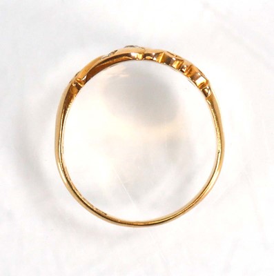 Lot 597 - An 18ct yellow gold ring set three small...