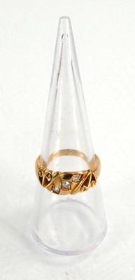 Lot 597 - An 18ct yellow gold ring set three small...