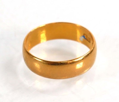 Lot 599 - A 22ct yellow gold wedding band, Birmingham...