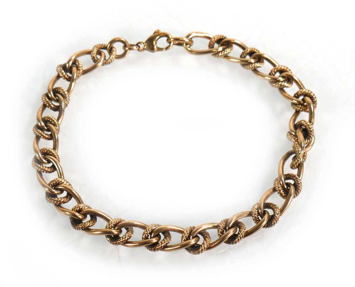Lot 603 - A 9ct yellow gold engraved and plain curblink...