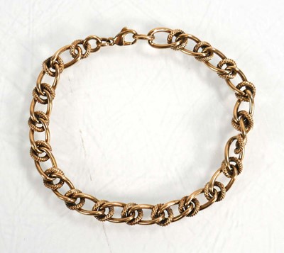 Lot 603 - A 9ct yellow gold engraved and plain curblink...