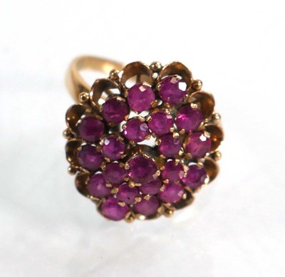 Lot 612 - A yellow metal cluster ring set small rubies...