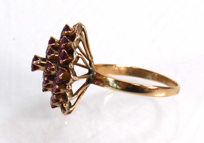 Lot 612 - A yellow metal cluster ring set small rubies...