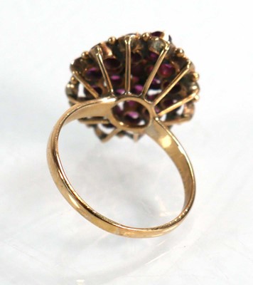 Lot 612 - A yellow metal cluster ring set small rubies...
