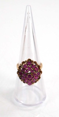 Lot 612 - A yellow metal cluster ring set small rubies...