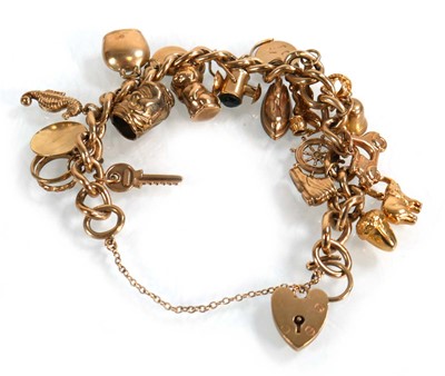 Lot 624 - A 9ct yellow gold curblink bracelet with heart...