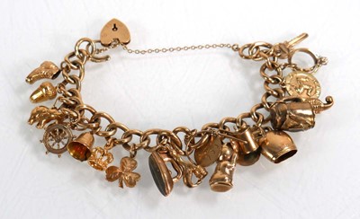 Lot 624 - A 9ct yellow gold curblink bracelet with heart...