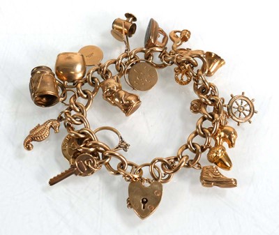 Lot 624 - A 9ct yellow gold curblink bracelet with heart...
